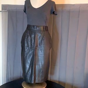 100% Leather skirt. Length just below the knee. Short split in back. Belt loops